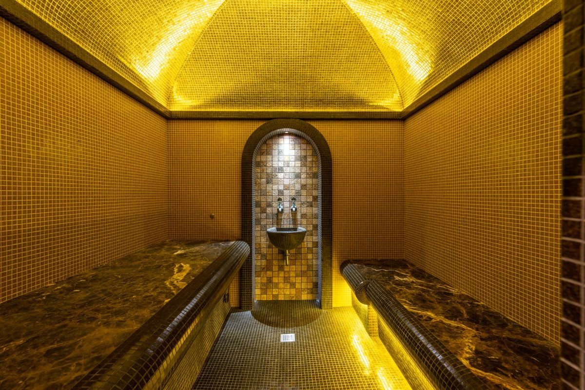 Placeholder — mosaic bathhouse interior with warm lighting (stock photo)
